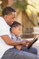 Mixed Race Father and Son Using Touch Pad Computer Tablet