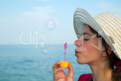 Teen girl blowing bubbles