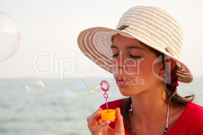 Teen girl blowing bubbles