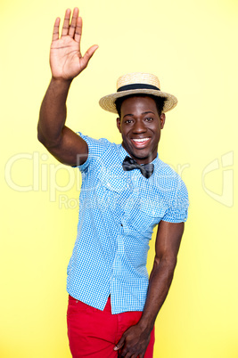 Casual young african guy posing with raised arm
