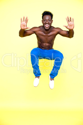 Shirtless young guy jumping high in the air