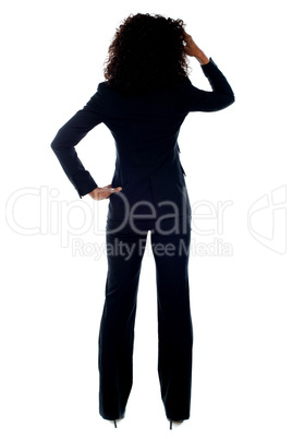 Rear view portrait of confused businesswoman