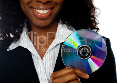 Cropped image of smiling woman showing DVD