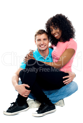 African teenager sitting on boyfriends lap
