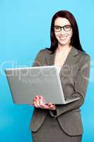 Young corporate woman working on laptop