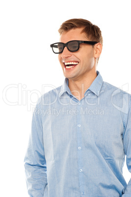 Joyful young man wearing goggles looking away