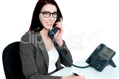 Young businesswoman holding phone receiver