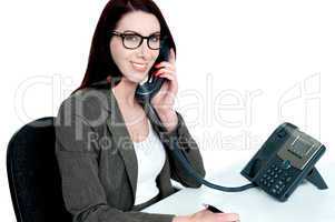 Young businesswoman holding phone receiver