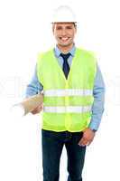 Smiling young architect holding blueprints