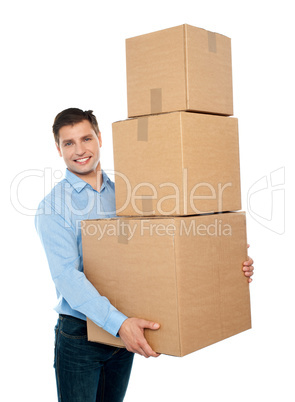 Happy young man carrying heavy packages