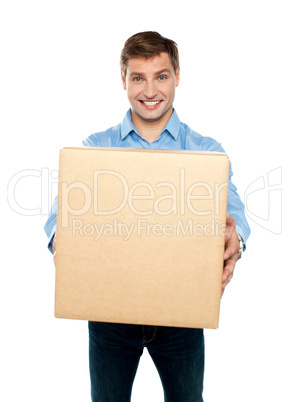 Charming handsome male holding carton