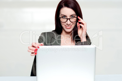 Lets call it a day. Woman shutting down laptop