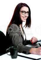 Pretty caucasian woman at work desk, writing
