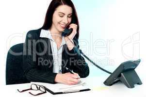 Smiling female operator attending clients call