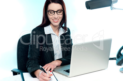 Businesswoman writing an important document