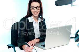 Businesswoman writing an important document