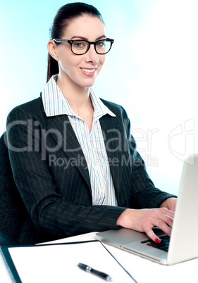 Corporate woman typing on laptop