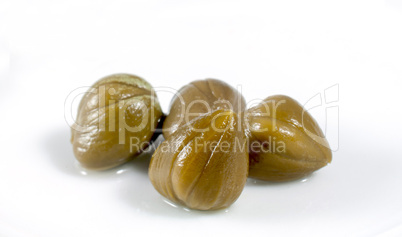green capers on white background