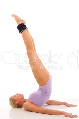 portrait of a young caucasian woman does gymnastics with ankle w