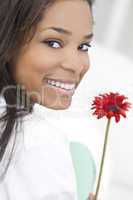 African American Woman Smiling with Red Flower