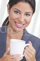 Happy Hispanic Woman Drinking Tea or Coffee