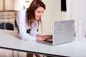 woman in the kitchen with laptop