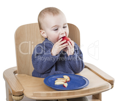young child eating peaches in high chair