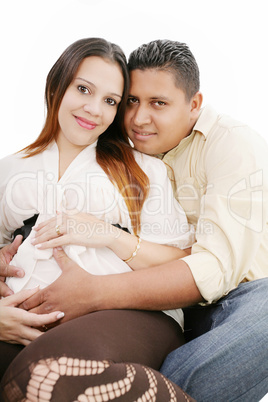 Happy pregnant couple expecting their baby over white