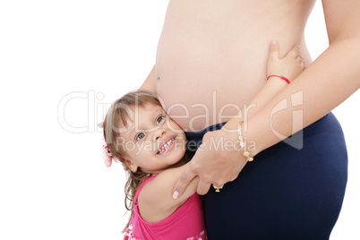 Pregnant mother with her small daughter studio shot