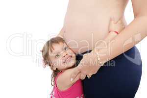 Pregnant mother with her small daughter studio shot