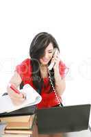 Smiling young business woman on phone taking notes in office