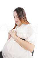 Young woman pregnant praying isolated on a white background