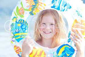 portrait of a beautiful little girl with a color lifebuoy