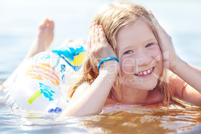 portrait of a beautiful little girl with a color lifebuoy