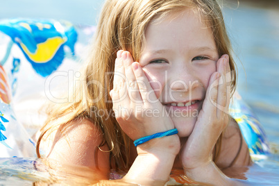 portrait of a beautiful little girl with a color lifebuoy