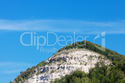 mountain with trees against the blue sky