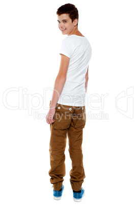 Trendy young boy turning back