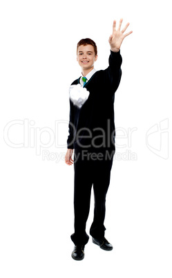 Cheerful young boy throwing paper