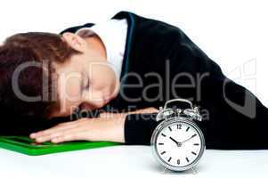 Tired schoolboy sleeping on calculator