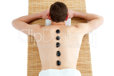 Man receiving hot stone therapy massage
