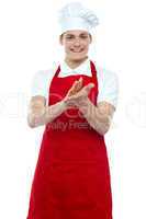Isolated young handsome male chef clapping