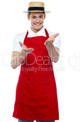 Handsome young male chef welcoming with smile