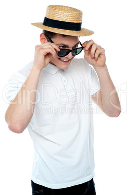 Man looking from behind sunglasses and smiling