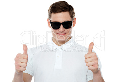 Handsome guy gesturing double thumbs up