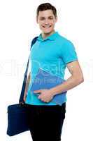 Smiling guy holding notepad and laptop bag
