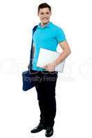 Cheerful man carrying laptop, off to work