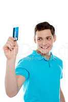 Handsome young man holding credit card