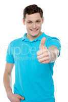 Handsome casual smiling guy showing thumbs up