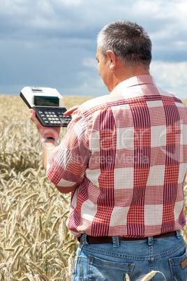 Farmer with computing machine in the field