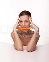 Sexy brunette with a carrot